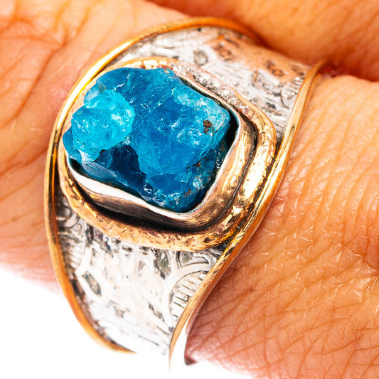 Sterling silver ring with blue apatite stone in gold-tone bezel, close-up