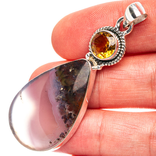 Sterling silver pendant close-up on round amber citrine and teardrop plume agate