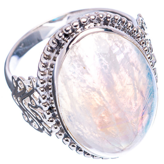 Oval rainbow moonstone cabochon set in detailed sterling silver ring, side scrollwork