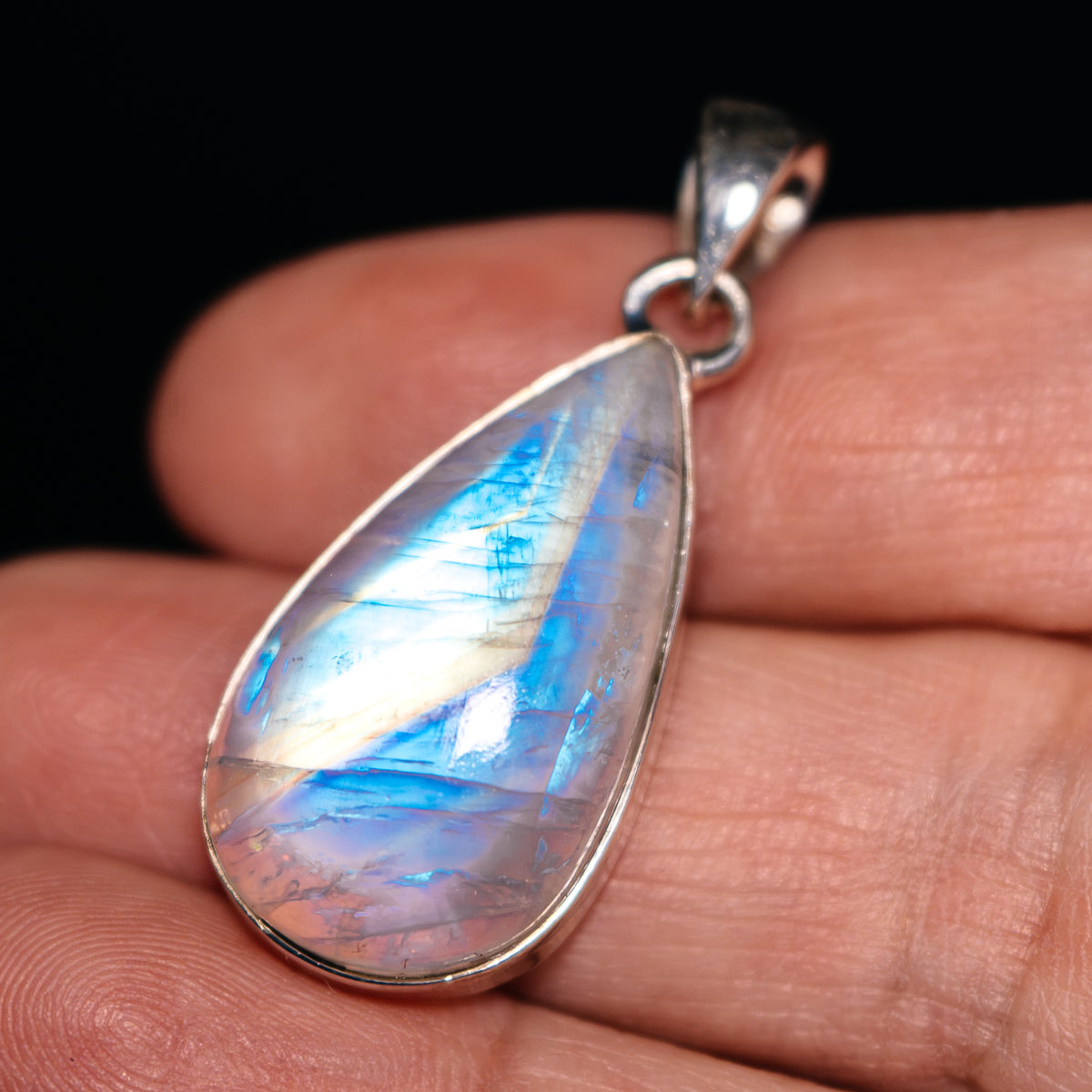 Sterling silver teardrop rainbow moonstone pendant with blue iridescent glow
