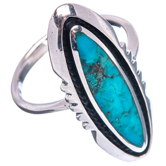 Sterling silver turquoise ring with oval stone, black bezel, and openwork band, side view