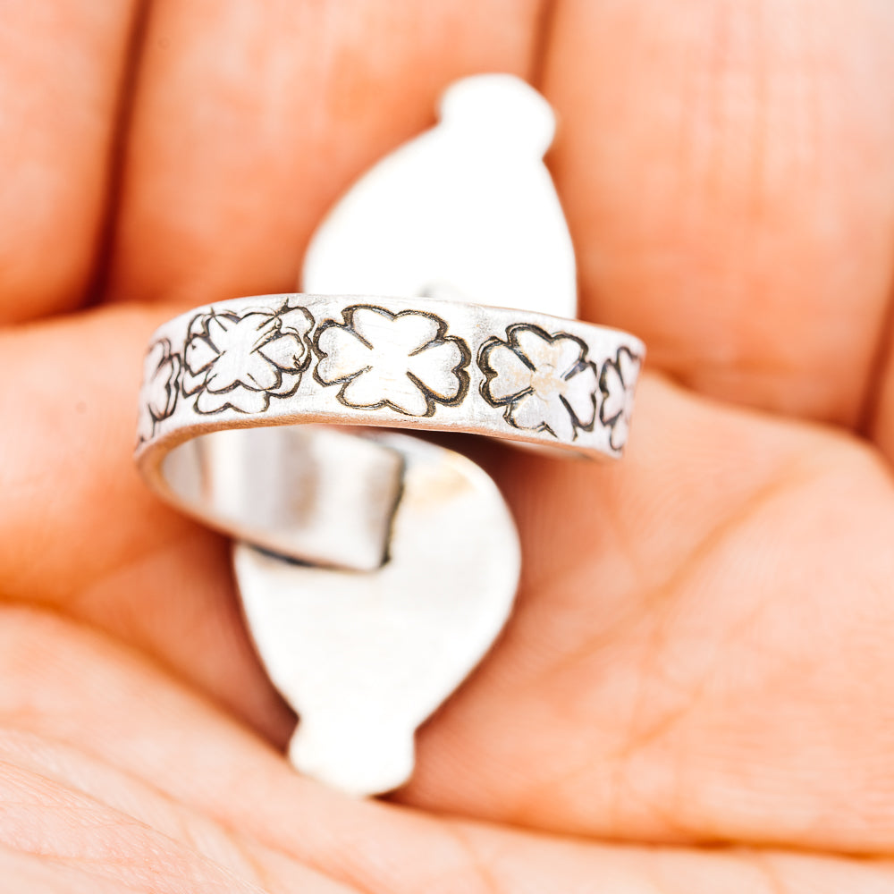 Sterling silver ring band with engraved floral pattern, cuff-style openwork