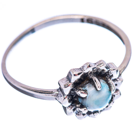 Sterling silver band ring with light-blue round gemstone in raised floral prong bezel