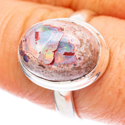 Sterling silver fire opal ring with bezel-set oval opal, detailed top view