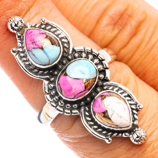 Silver-tone oval gemstone ring with turquoise, pink, and white stones on band
