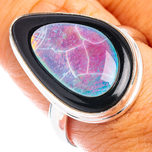 Sterling silver ring with oval opal set in black bezel, multicolor flashes