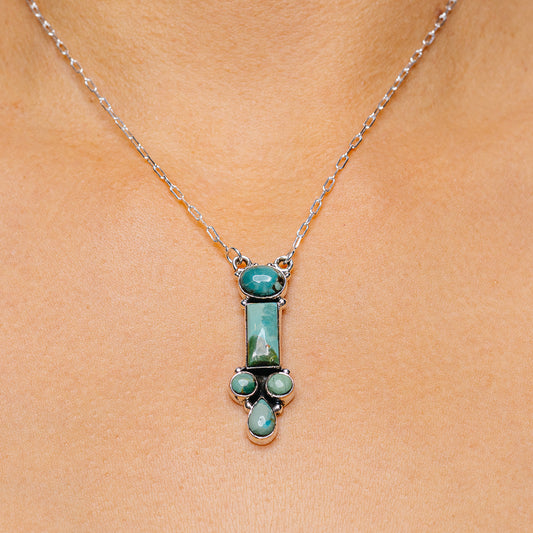 Sterling silver turquoise pendant necklace with oval stone and teardrop accents