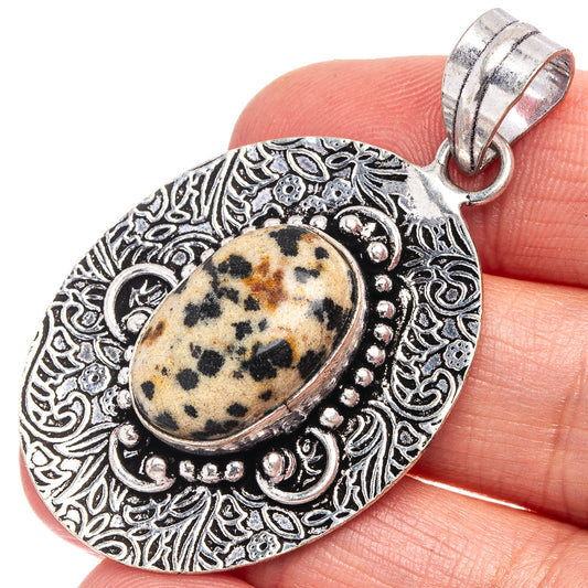 Dalmatian jasper pendant with silver-tone ornate bezel and round engraved frame, top bail