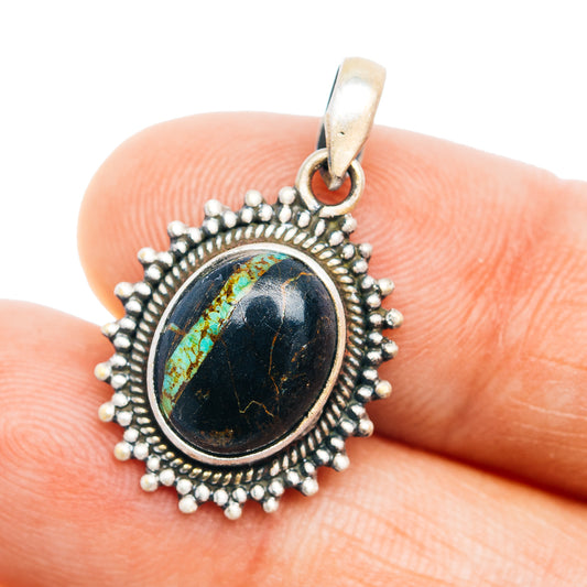 Black oval turquoise pendant with beaded silver frame and bail on sterling silver
