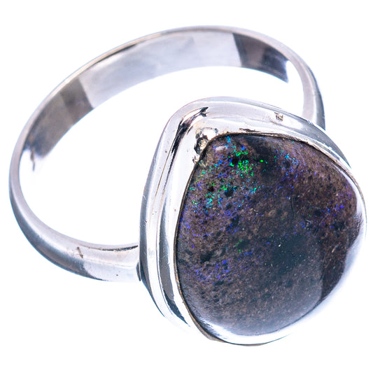 Sterling silver ring with oval matrix opal set in raised bezel, iridescent green-blue