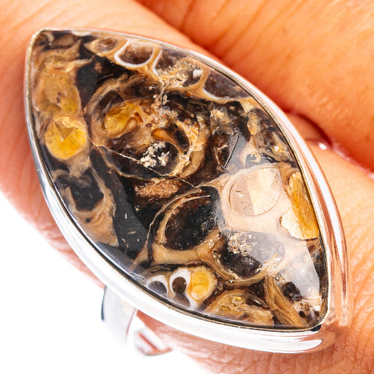 Turritella agate oval ring with sterling silver bezel, dark amber and black pattern