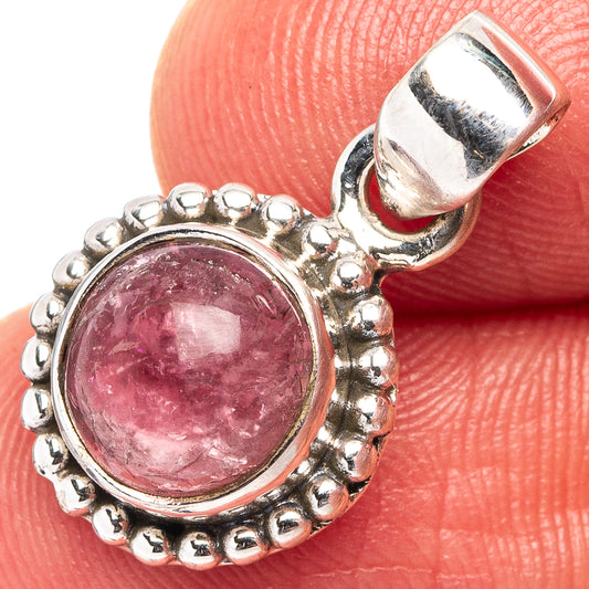 Pink tourmaline pendant with round pink gemstone in silver bezel, hinged bail