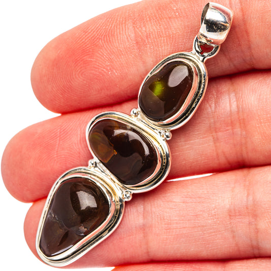 Sterling silver fire agate pendant with three dark oval stones and polished bezels