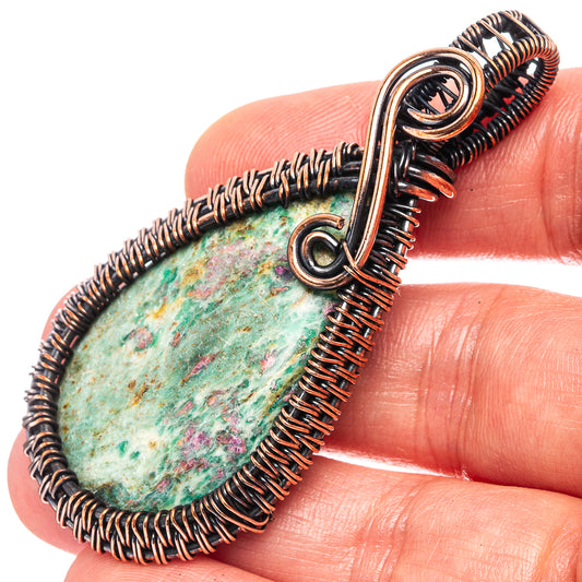 Oxidized copper wire-wrapped teardrop pendant with green-blue gemstone cabochon
