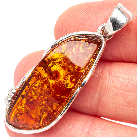 Amber teardrop pendant in .925 sterling silver with polished bail and oval amber center