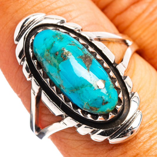Sterling silver ring with oval turquoise centerpiece and decorative sidework