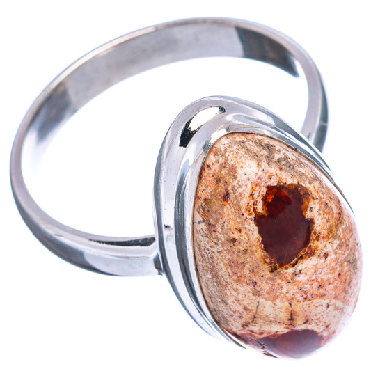 Oval fire opal set in .925 sterling silver ring, side view of red-brown stone