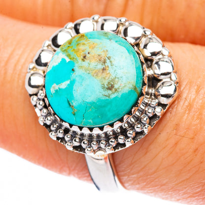 Turquoise cabochon sterling silver ring with oval stone and beaded halo setting
