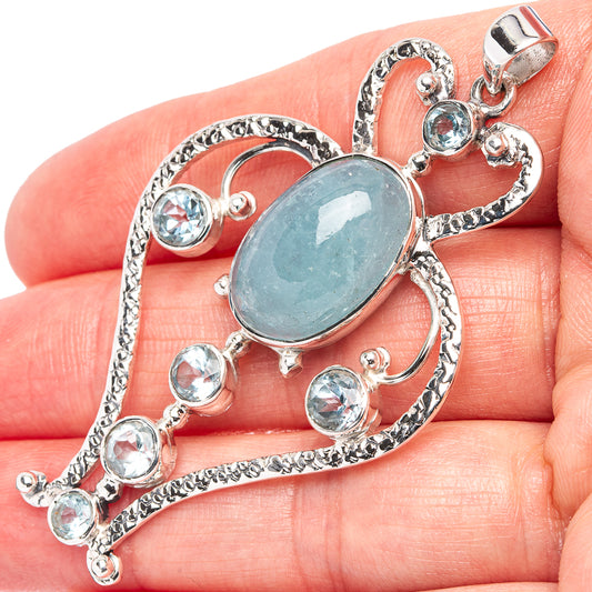 Aquamarine-blue oval pendant with round blue stones, .925 sterling silver setting