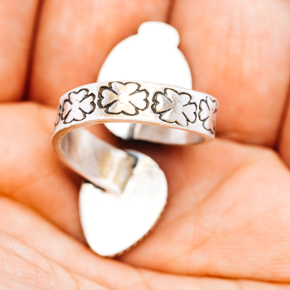 Silver-tone adjustable ring with engraved floral band and yellow oval stone
