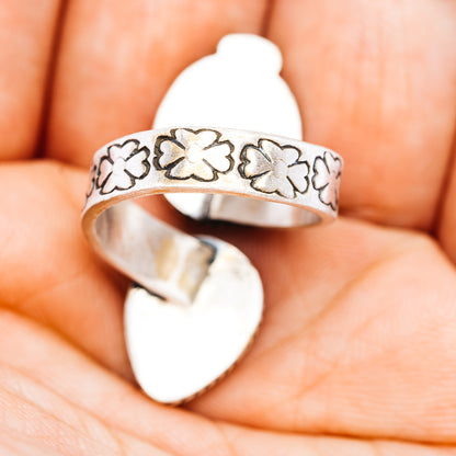 Silver-tone adjustable ring with engraved floral band and yellow oval stone