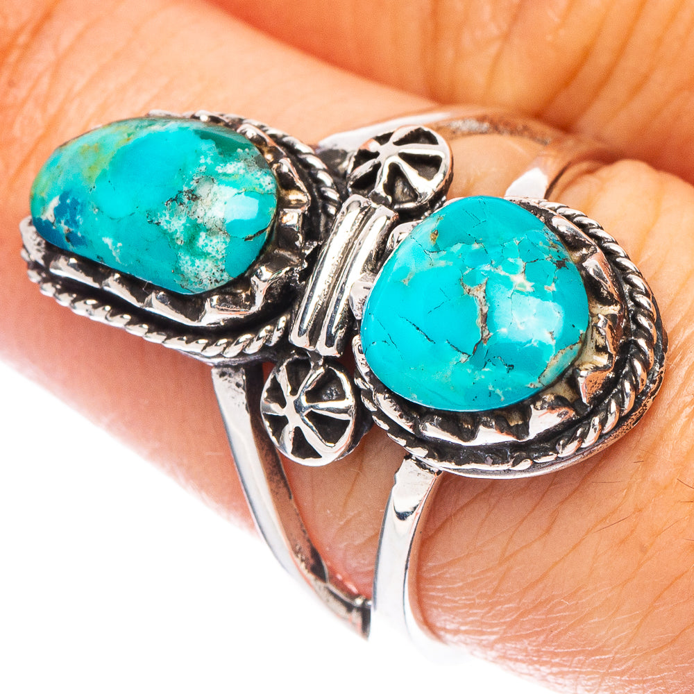 Sterling silver ring with two oval turquoise cabochons and ornate side details