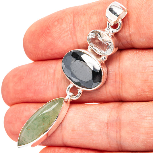 Sterling silver gemstone pendant with dark oval and green oval stones, polished bezel