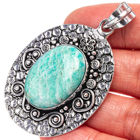 Amazonite oval pendant with turquoise cabochon and ornate silver-tone filigree bail