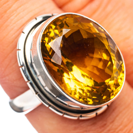 Oval amber quartz set in .925 sterling silver ring with polished bezel detail