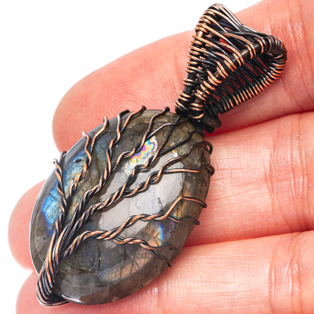 Labradorite tree of life pendant with oxidized copper wire and oval stone, blue-gray glow