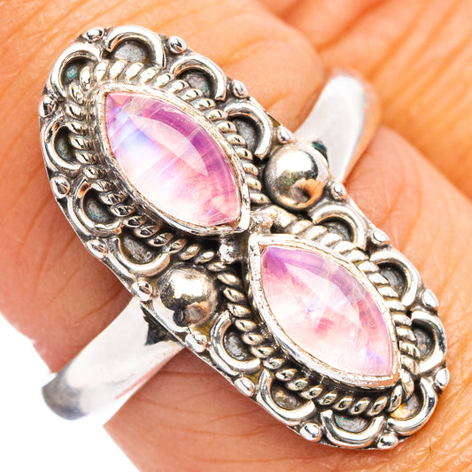 Sterling silver ring with two pink oval moonstone-like cabochons, ornate scalloped bezel