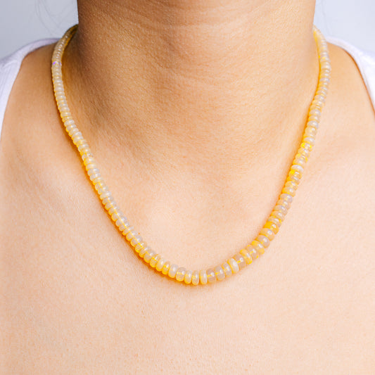 Opal bead necklace with small round yellow stones on a delicate chain