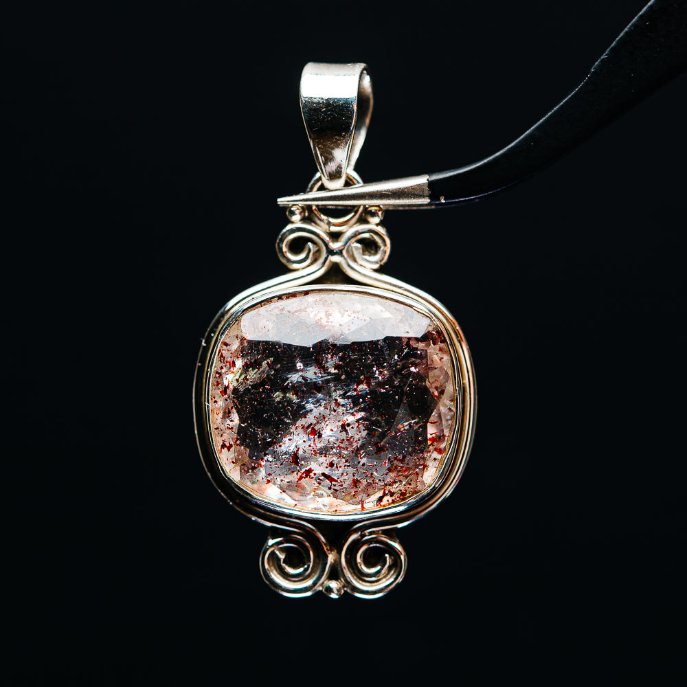 Sterling silver round pendant with faceted lepidocrocite stone and ornate swirl setting