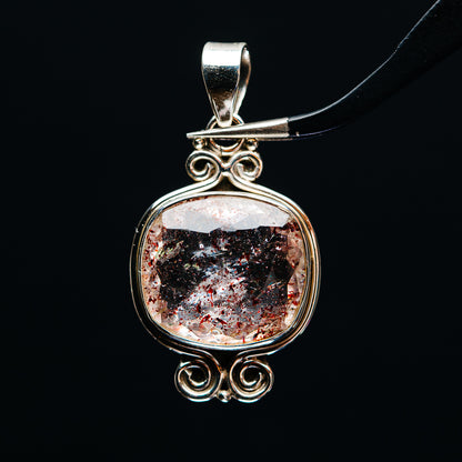 Sterling silver round pendant with faceted lepidocrocite stone and ornate swirl setting