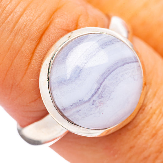 Sterling silver ring with large oval blue lace agate cabochon on finger
