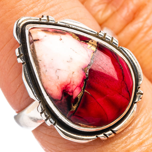 Sterling silver ring with oval red-pink marbled cabochon and decorative prong bezel