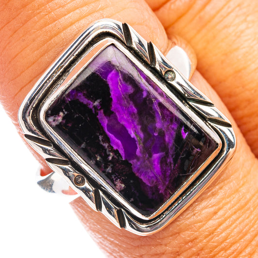 Sterling silver sugilite ring with rectangular purple stone, ornate bezel and side prongs