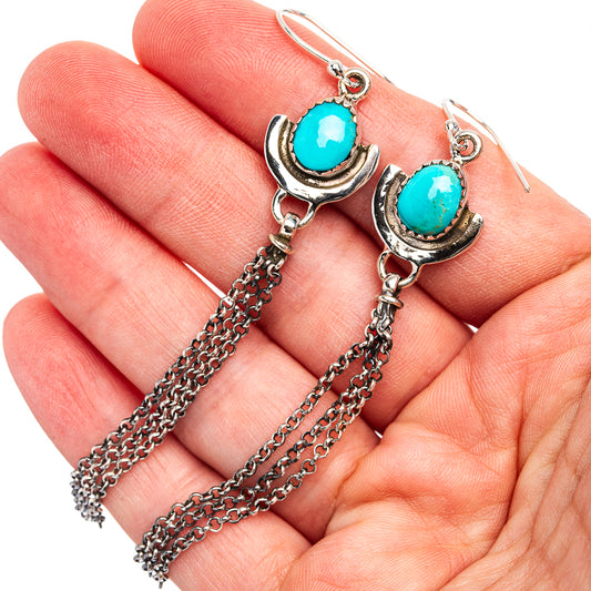Turquoise oval drop earrings with silver crescent caps and dangling chain tassels
