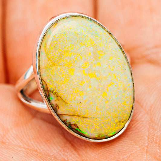 Oval opal sterling silver ring, side view; yellow body with green-orange flashes