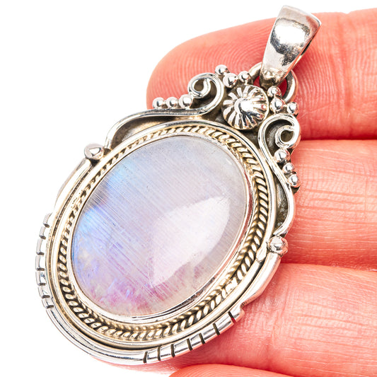 Oval rainbow moonstone pendant in .925 sterling silver, ornate bezel and bail