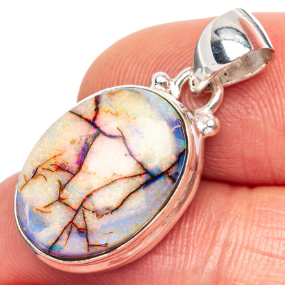 Oval opal pendant in silver bezel with open-back bail and faceted rainbow coloring