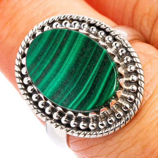 Malachite cabochon ring with oval green stone in ornate sterling silver bezel