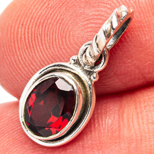 Oval garnet gemstone pendant in .925 sterling silver, close-up of bezel and bail.