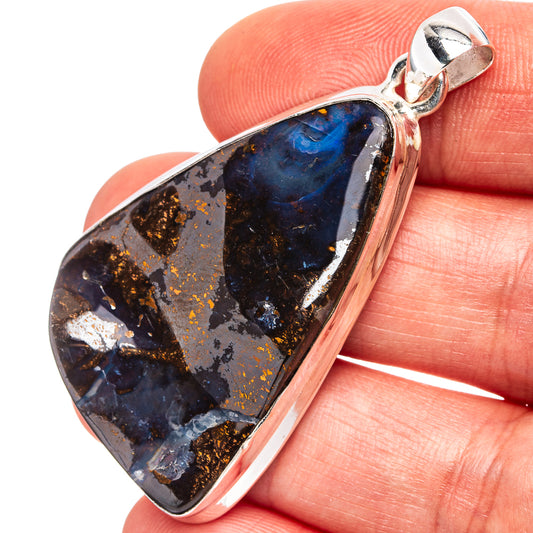 Sterling silver boulder opal pendant in teardrop shape with dark blue and gold flecks