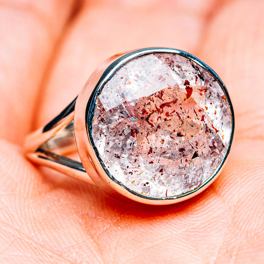 Faceted lepidocrocite ring with silver bezel, white stone with copper-gold flecks