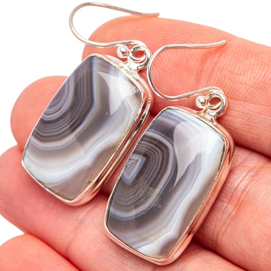 Banded Botswana agate drop earrings in .925 sterling silver, close-up with gray and white swirls