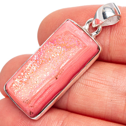 Pink druzy quartz pendant with sterling silver rectangular bezel and bail, close-up.