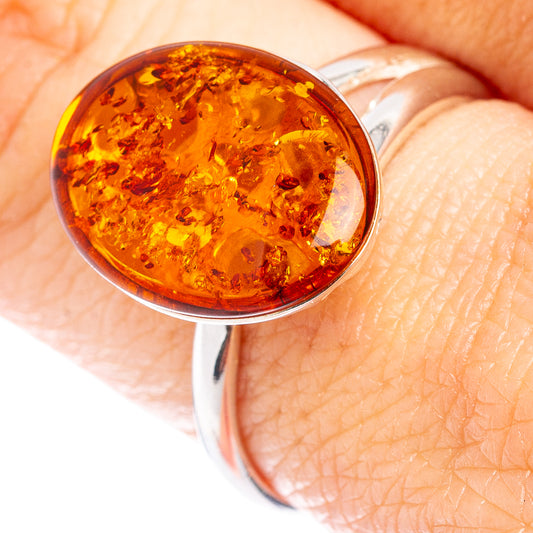 Amber cabochon ring in .925 sterling silver, open band with warm orange stone close-up
