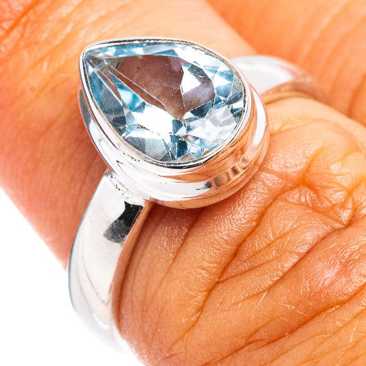 Sterling silver ring with faceted blue topaz oval stone in a round bezel setting
