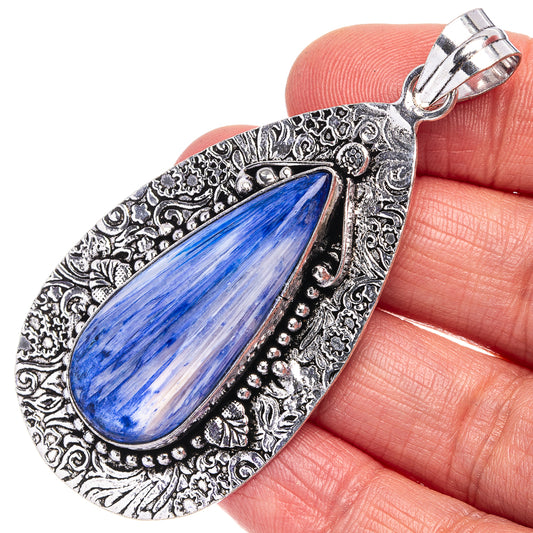 Blue teardrop pendant necklace charm with ornate silver frame and bail